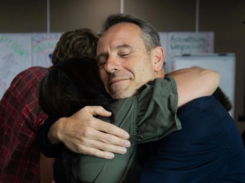 An emotional embrace at a Break Free Experience event